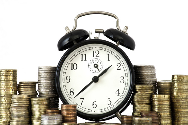 TIME IS MONEY concept: alarm clock and lots of euro coins